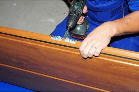 A man repairing garage door panel